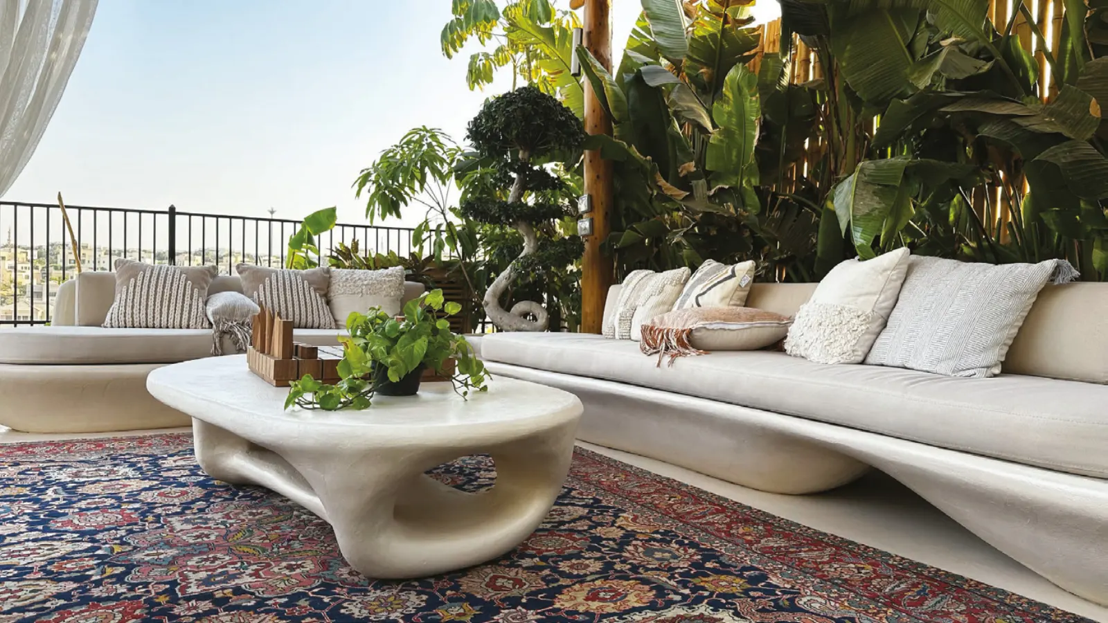 Sculpted organic coffee table and built-in seating on a terrace
